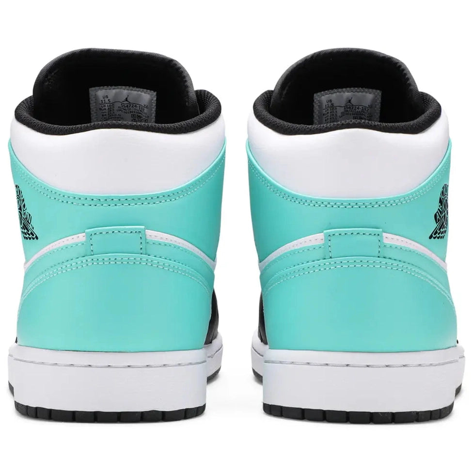 Back view of mint green and white mid-top sneakers with black soles and logo details