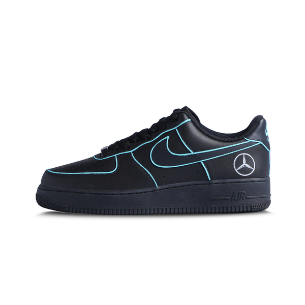 Black streetwear sneaker with blue accents, Mercedes logo on heel, and low-top design