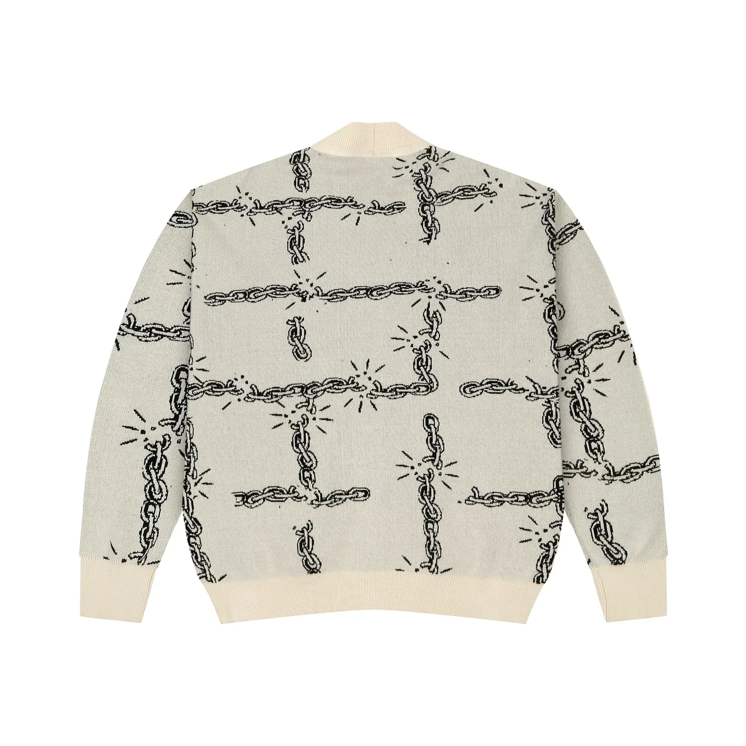 Cream knit sweater with black broken chain pattern and ribbed cuffs and hem