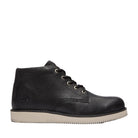 Black leather boot with white sole on a light gray background