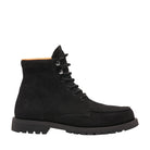 Black boot with orange lining on a light gray background