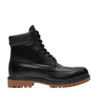 Black leather boot with brown sole on a light gray background