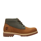 Brown and green boot with Timberland logo on a white background