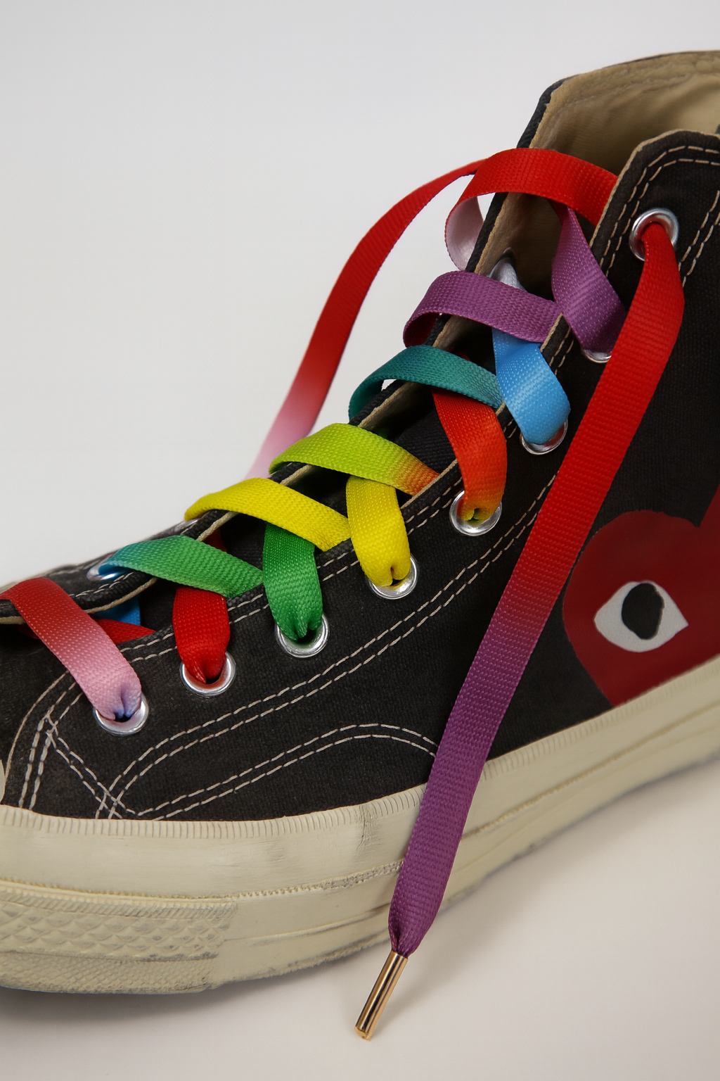 Black high-top sneaker with colorful Gradient shoelaces on a white background