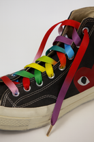 Black high-top sneaker with colorful Gradient shoelaces on a white background
