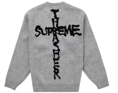 Gray knit sweater with black graphic cross and bold streetwear-style lettering on back