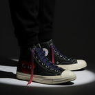 Black High top shoes worn with Red - Purple - Light Pink Gradient shoelaces on the shoe