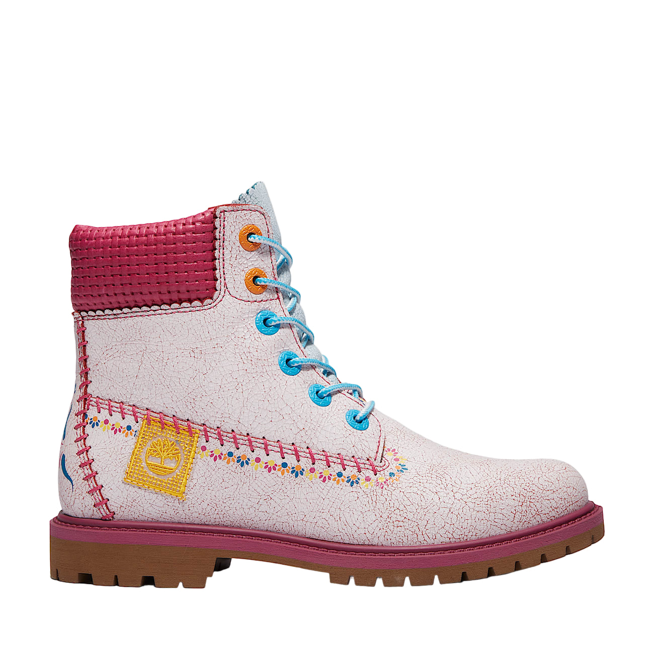 White boot with pink top and colorful stitching on a white background