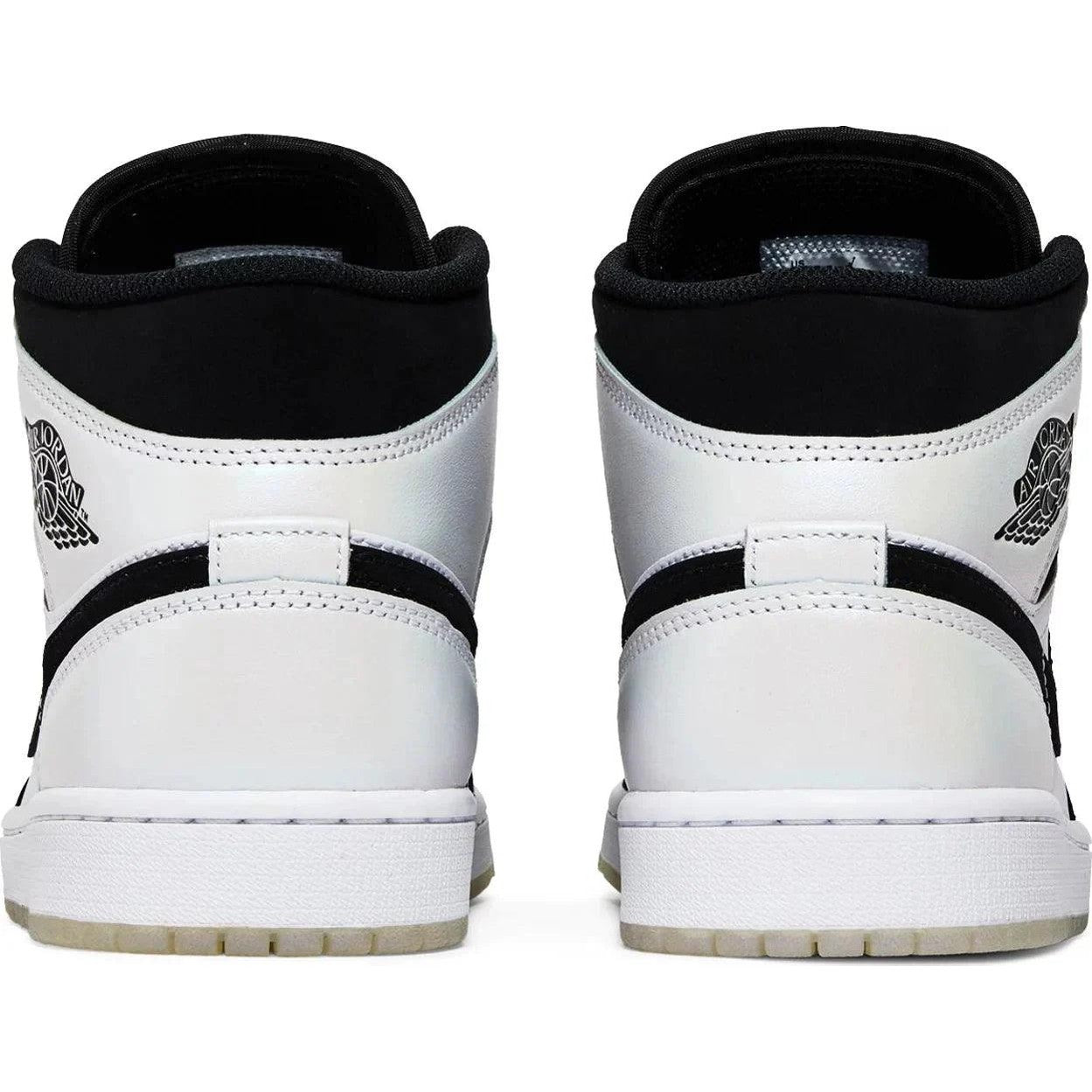 Back view of white and black Air Jordan 1 Mid SE Diamond sneakers on white background