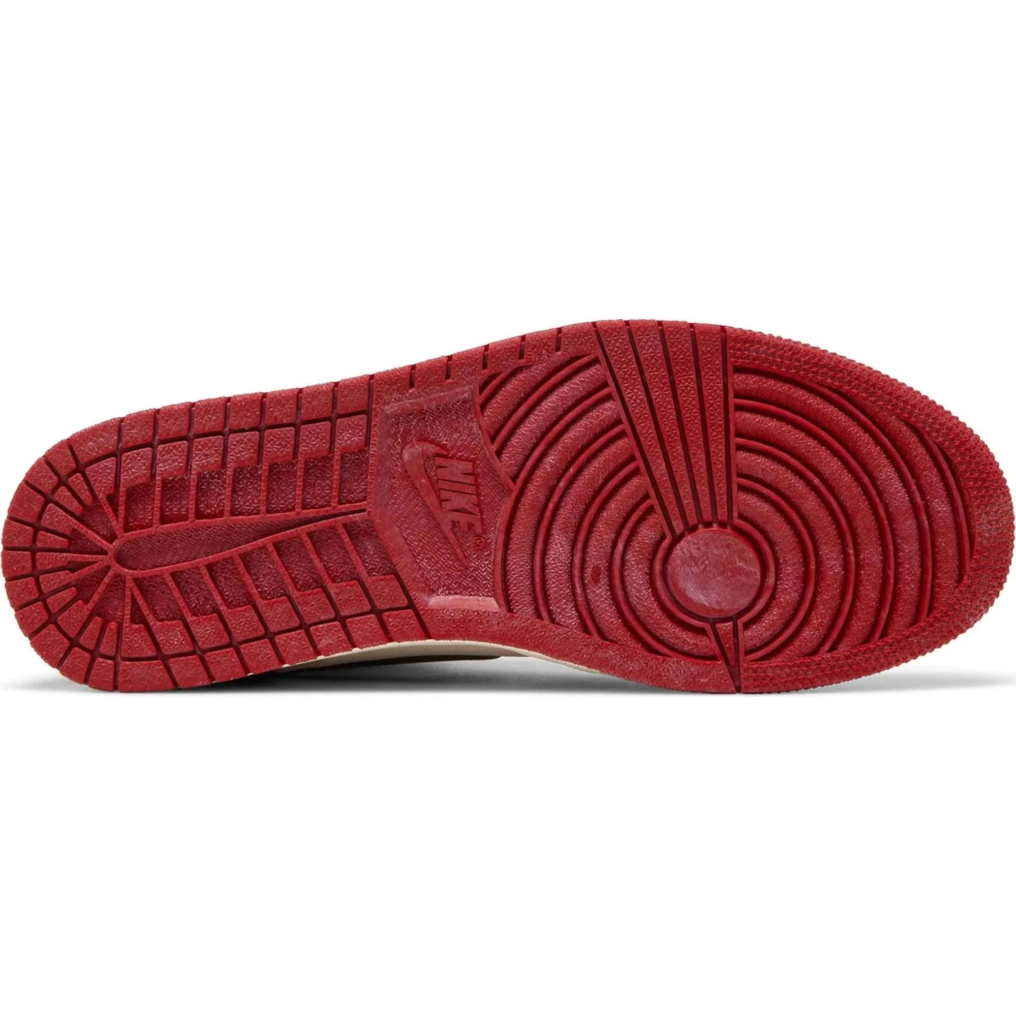 Red outsole of Air Jordan 1 Retro High OG sneaker with Nike logo and traction pattern