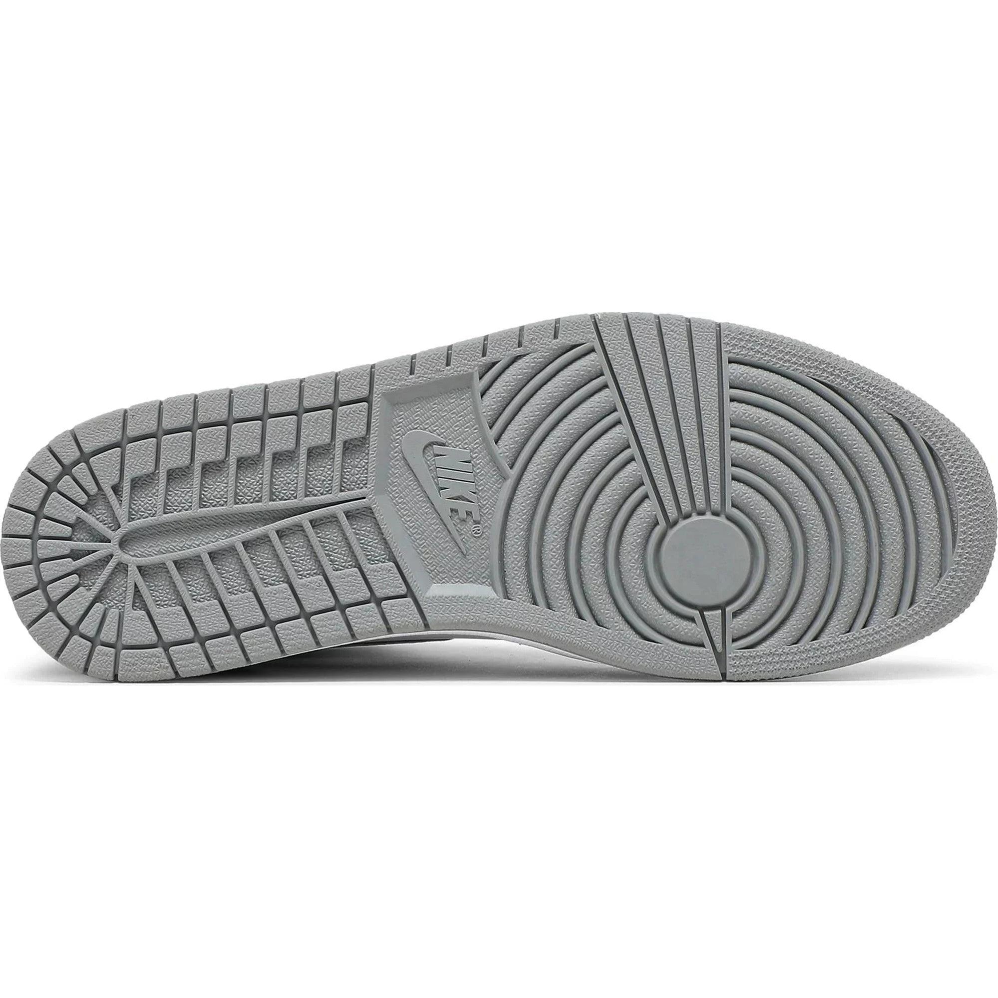 Grey rubber outsole of high-top sneaker with circular and grid traction pattern, Nike logo visible.