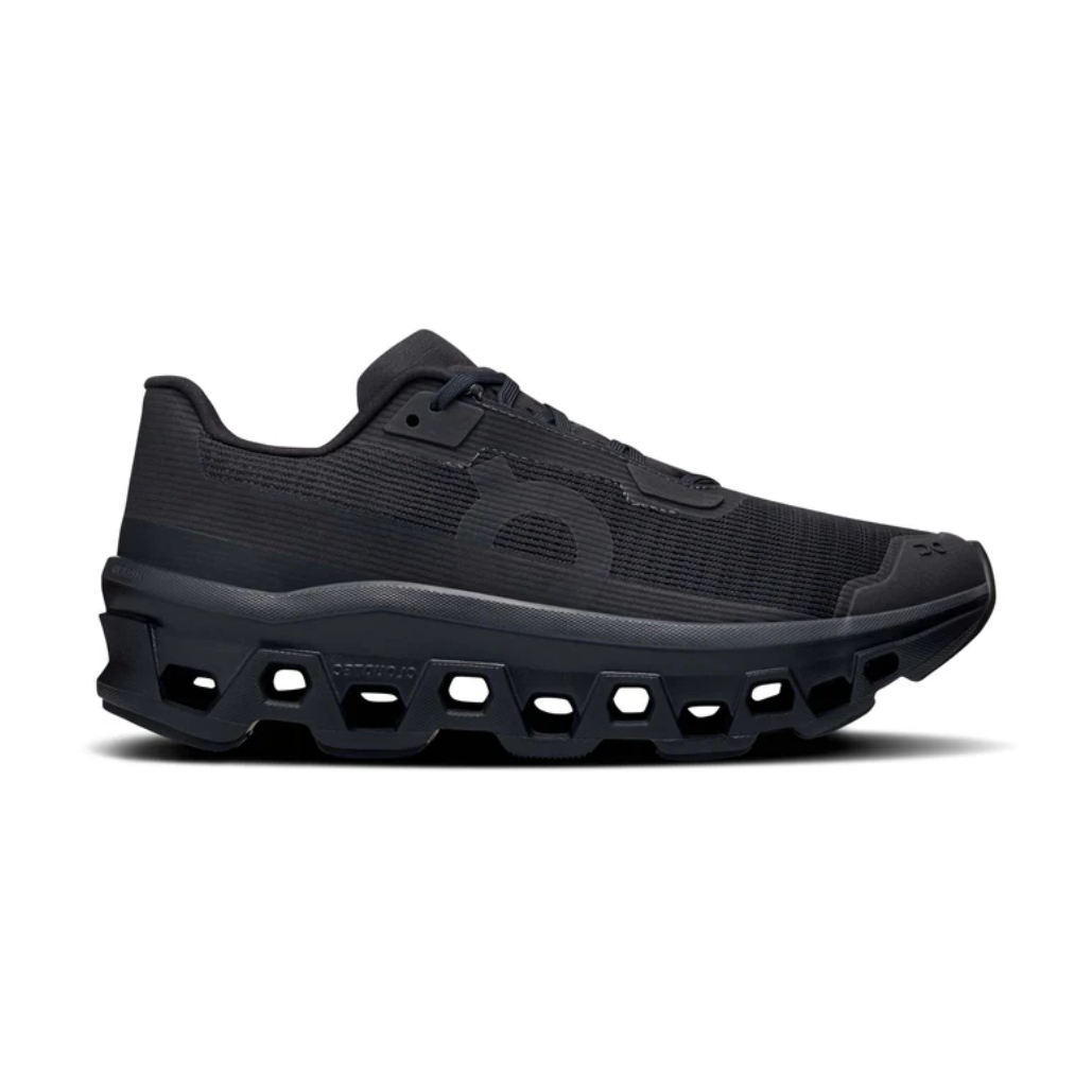 Black designer sneaker with mesh upper and unique geometric chunky sole, side profile view