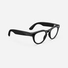 Black round frame eyeglasses with clear lenses and logo on temple against white background.