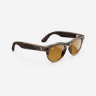 Brown translucent wayfarer sunglasses with amber lenses on white background