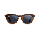 Brown tortoiseshell sunglasses with dark lenses, classic round shape, and streetwear style.