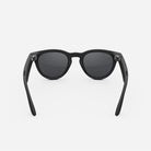 Black round-frame sunglasses with dark lenses, modern streetwear accessory on white background.