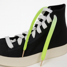 Black high top shoes and the shoelaces worn are Neon green and white gradient shoelaces on a white background