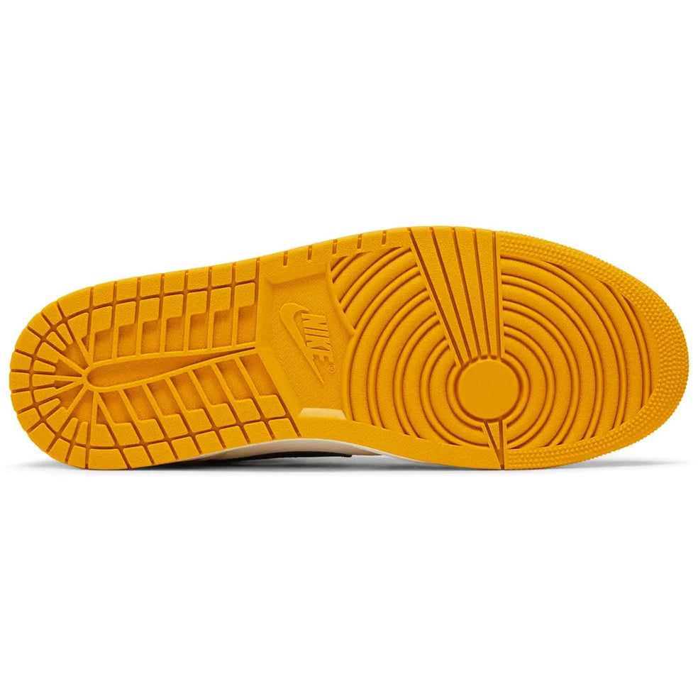 Yellow rubber sole of a Nike Air Jordan 1 Retro High OG sneaker, detailed tread pattern