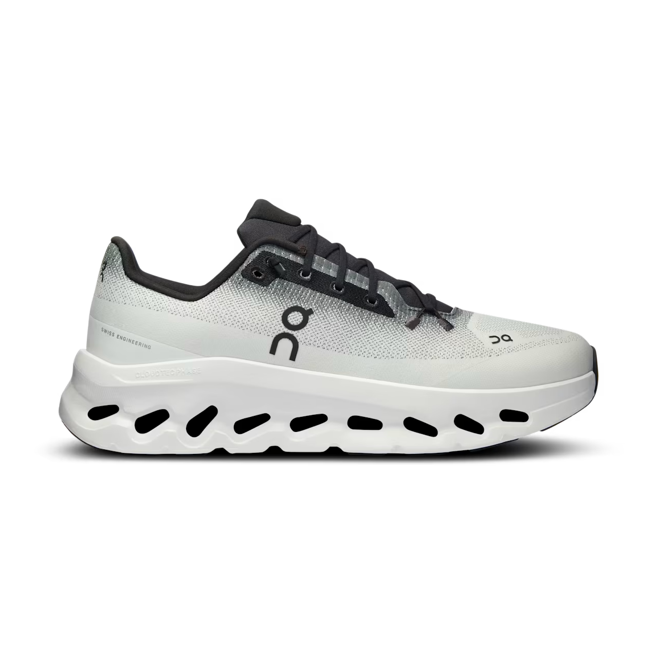 Light grey and black designer sneaker with thick, ventilated white sole on white background