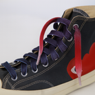 Close up of a sneaker with  Red - Purple - Light Pink Gradient shoelaces on the shoe