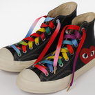Black high-top sneakers with colorful Gradient laces on a white background