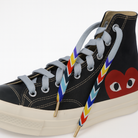 Black high-top sneaker with gradient colorful laces on a white background