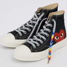 Black high-top sneakers with  gradient colorful shoelaces on a white background