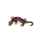 Gold-tone gecko sneaker charm with pink and green crystal detailing on black background