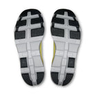 Close-up of black and white sneaker soles with textured grip and yellow detail, streetwear footwear